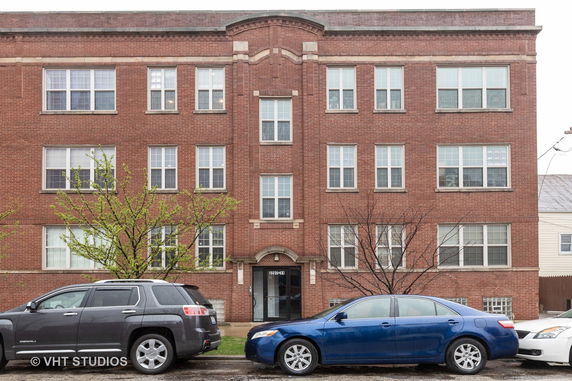 Front view of a three-story brick apartment building