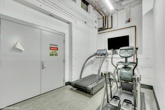 Indoor exercise area with a treadmill and elliptical machine.