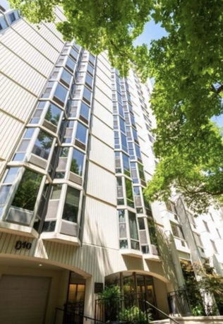 Front view of a multi-story building with large windows and a modern facade.