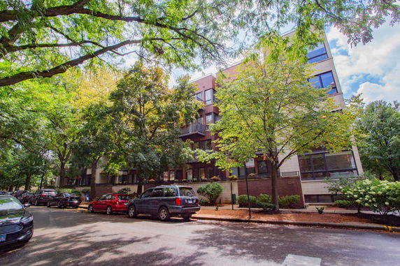 Front view of a multi-story residential building with balconies.