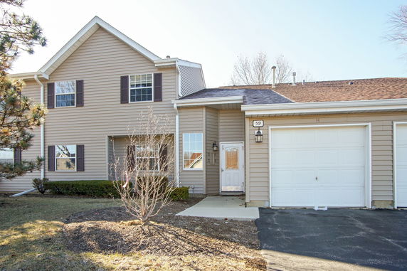 Front view of a two-story house with a single garage.