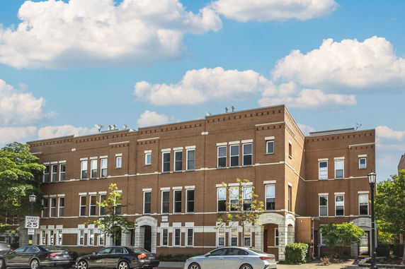 Front view of a two-story brick building with multiple windows.