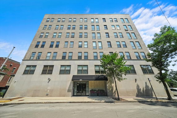 Front view of a multi-story building with multiple windows.