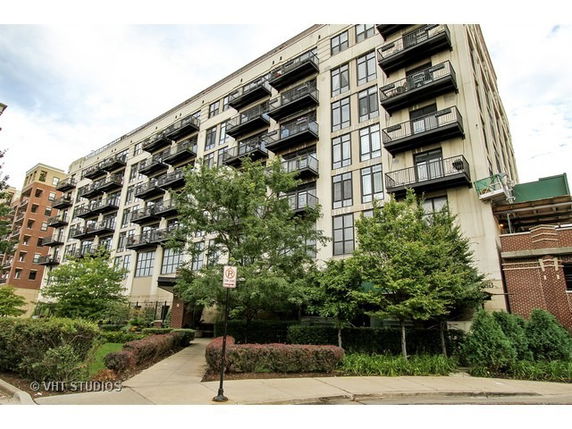 Front view of a multi-story residential building with balconies.