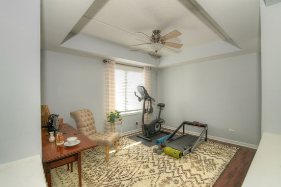 Room with exercise equipment and a chair.