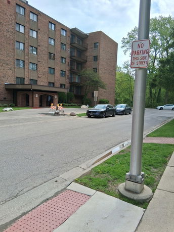 Front view of a multi-story brick building with a covered entrance.