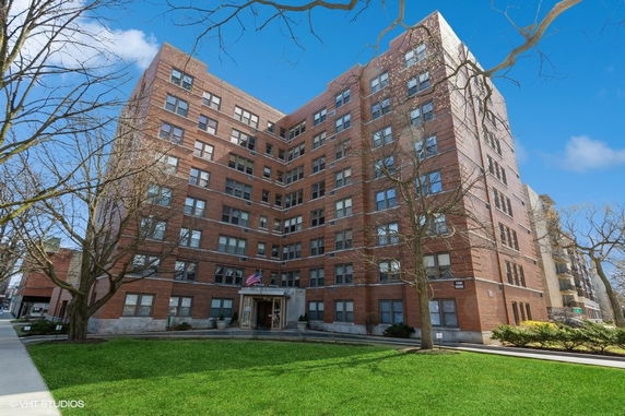 Front view of a multi-story brick apartment building.