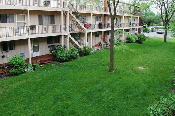 Front view of a multi-story apartment building with balconies.