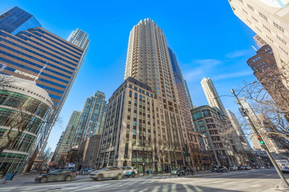 Front view of a tall skyscraper in an urban setting.