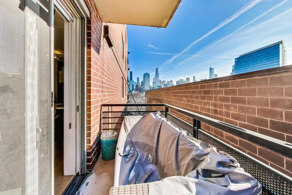 View from a balcony overlooking a cityscape with skyscrapers in the distance.