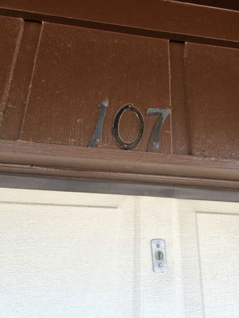 Front view of a building entrance with the number 107.