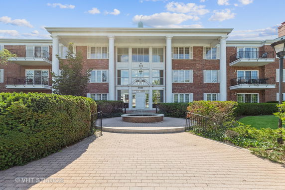 Front view of a multi-story building with large columns and balconies.