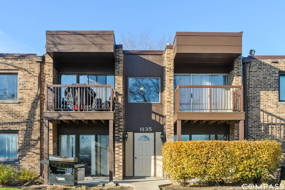 Front view of a two-story brick building with balconies.