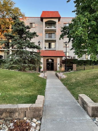 Front view of a multi-story building with a red roof entrance.