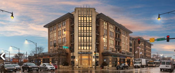 Front view of a multi-story commercial building on a street corner.