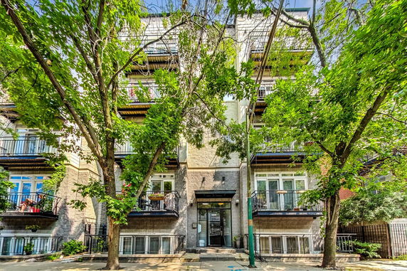 Front view of a multi-story residential building with balconies.