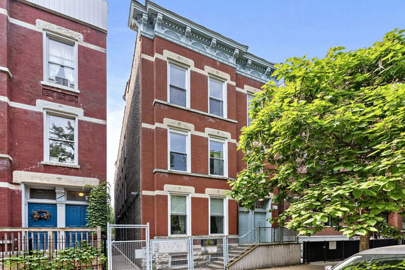 Front view of a three-story brick apartment building.