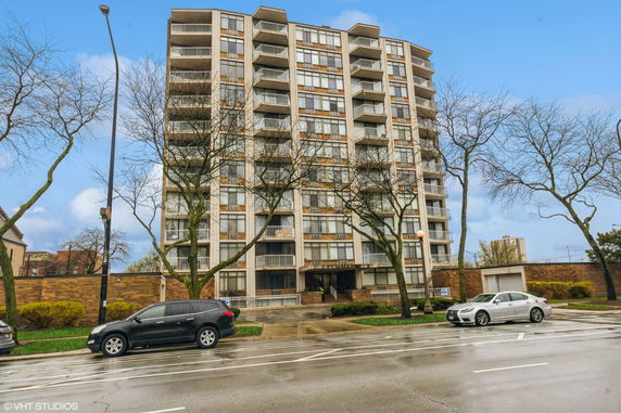 Front view of a multi-story apartment building with balconies.