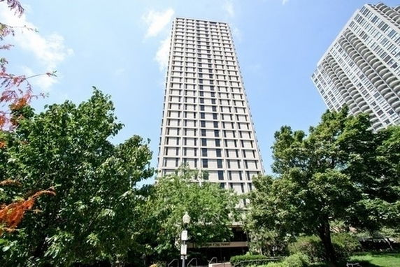 Front view of a tall residential building with multiple floors.