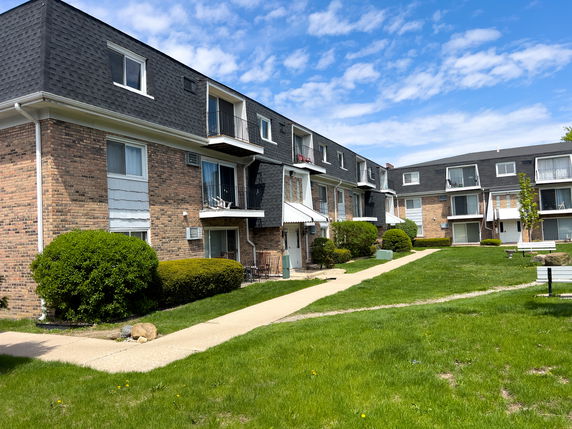 Front view of a multi-story apartment building with balconies.