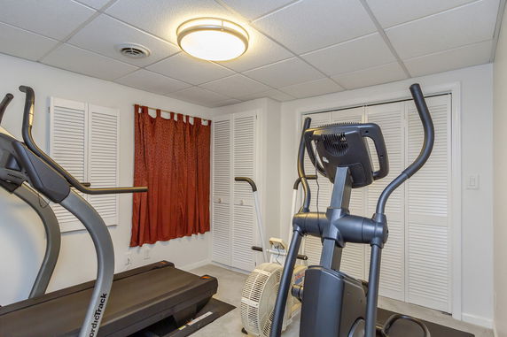 Indoor area with exercise equipment including a treadmill and elliptical machine