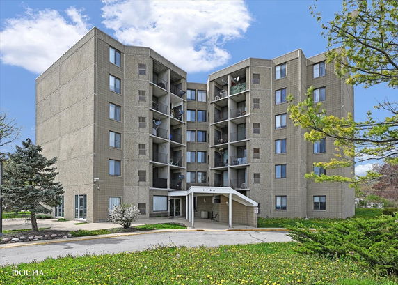 Front view of a multi-story residential building with balconies.
