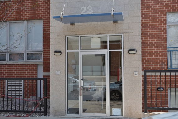 Front view of a building entrance with glass door and awning.