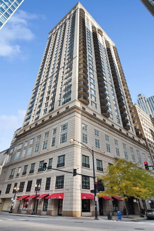 Front view of a tall high-rise building with multiple balconies.