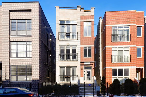 Front view of a multi-story residential building with a modern brick facade.
