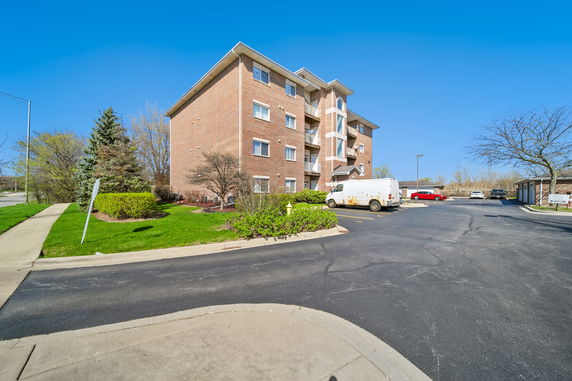 Front view of a large brick apartment building with multiple floors.
