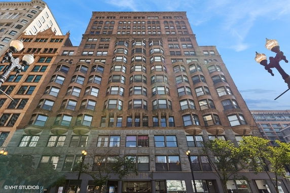 Front view of a tall, multi-story building with numerous windows.