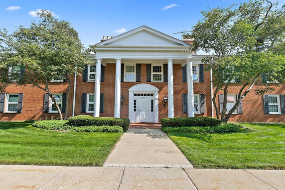 Front view of a two-story brick building with columns