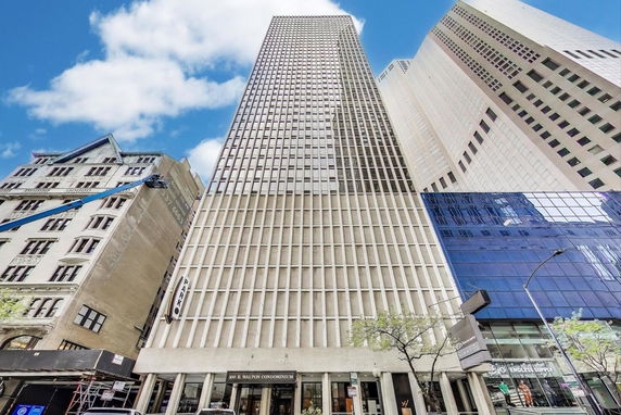 Front view of a tall multi-story building with a grid-like facade.