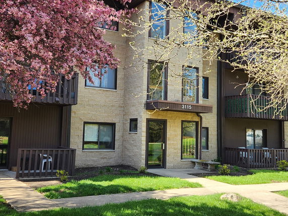 Front view of a multi-story residential building with balconies.