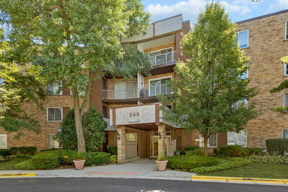 Front view of a multi-story building with balconies.