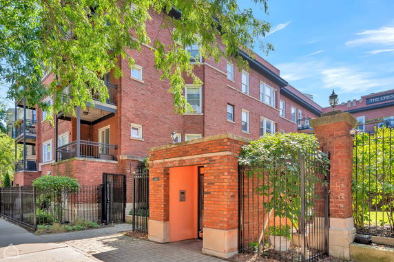 Front view of a multi-story brick building with balconies.