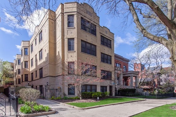 Front view of a multi-story brick apartment building.
