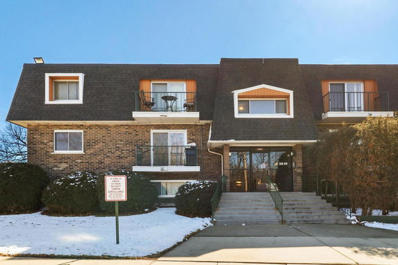 Front view of a multi-story building with balconies.