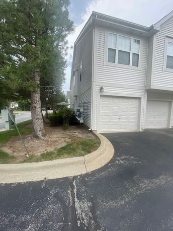 Front view of a townhouse with an attached garage.