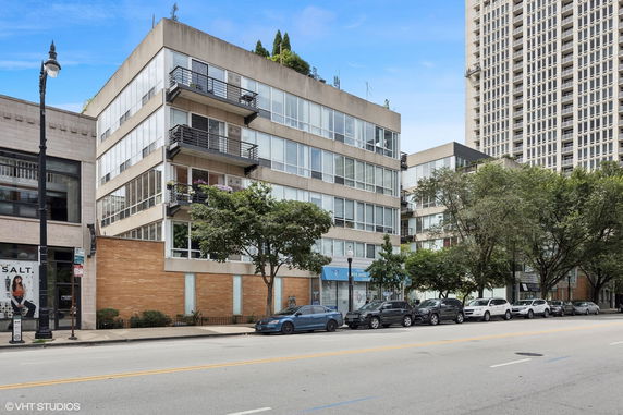 Front view of a multi-story commercial building with large windows and balconies.