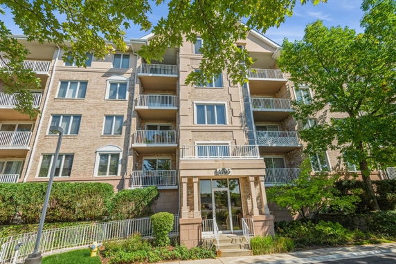 Front view of a multi-story residential building with balconies.