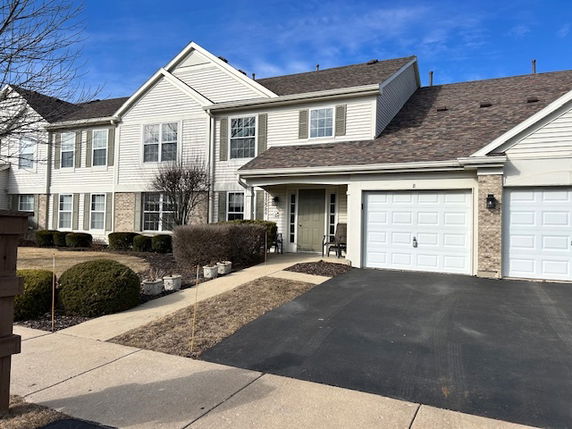 Front view of a two-story house with a double garage.