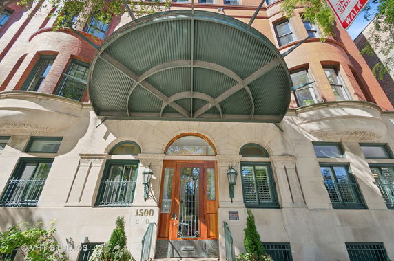 Front view of a multi-story building with a prominent entrance canopy.