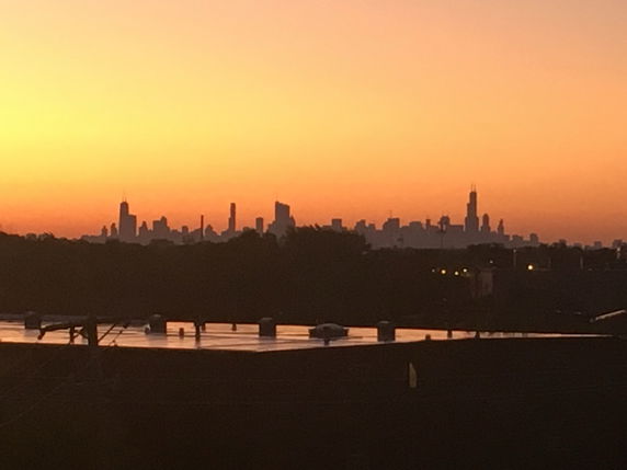 Panoramic view of a city skyline during sunset.