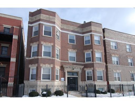 Front view of a three-story brick building with multiple windows and a central entrance.