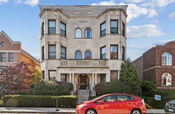 Front view of a three-story building with classical architectural features.