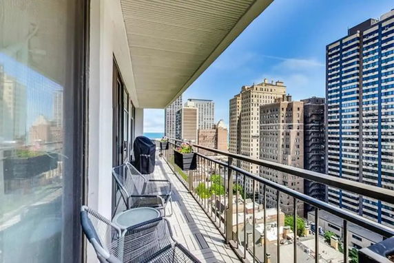 View from a building balcony with cityscape in the background.
