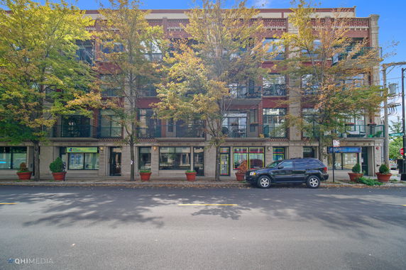Front view of a multi-story building with street-facing balconies.
