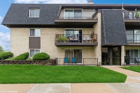 Front view of a multi-story residential building with balconies.