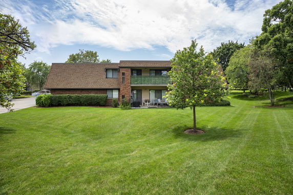 Front view of a two-story house with a sloped roof.